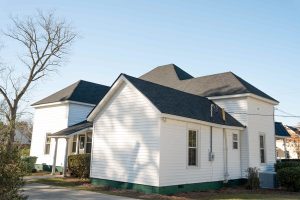 Statesboro Pathology Associates | Commercial Roofing Project After | Onyx Black Architectural Asphalt Shingles | Matte Black Standing Seam Metal Roofing