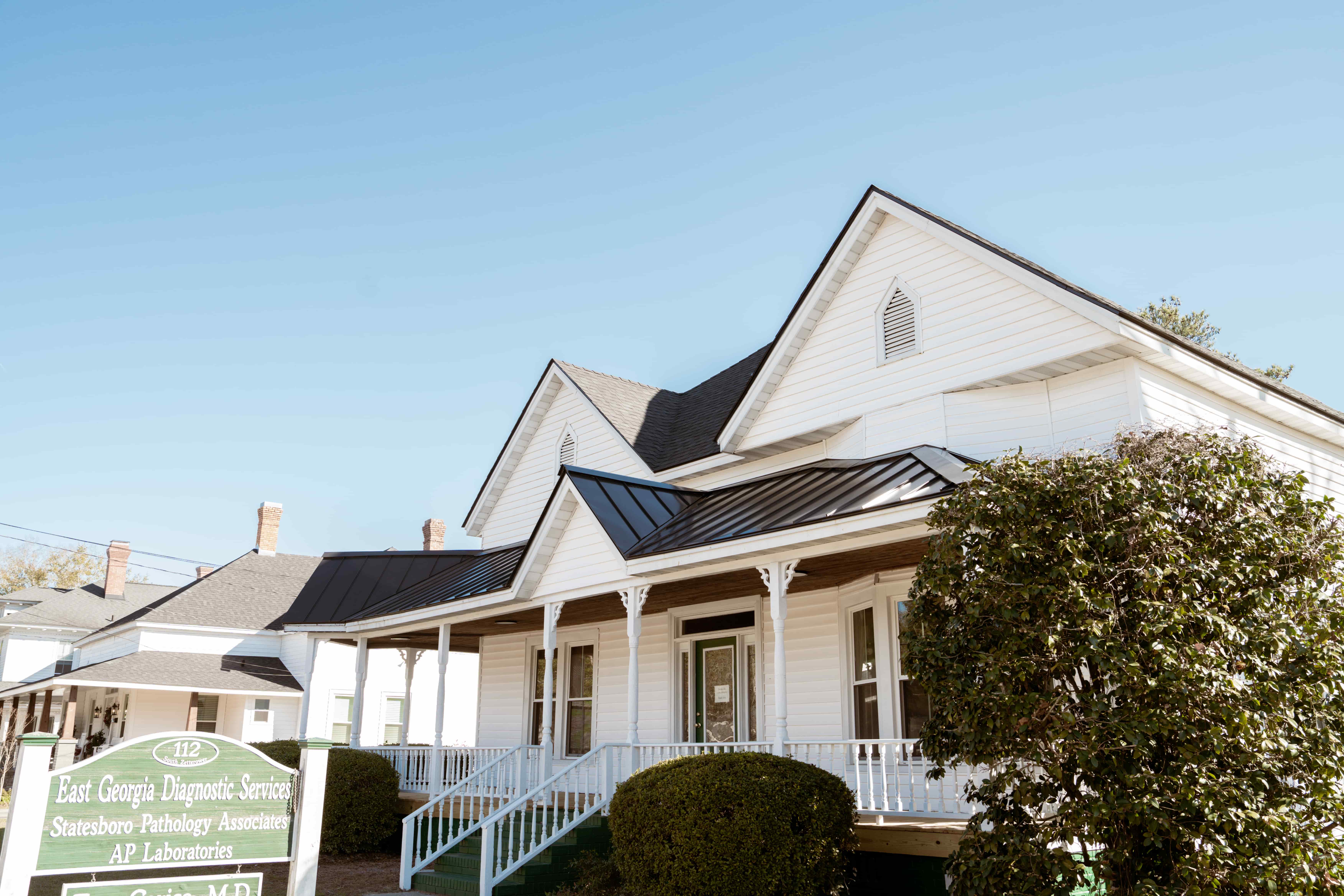 Statesboro Pathology Associates | Commercial Roofing Project After | Onyx Black Architectural Asphalt Shingles | Matte Black Standing Seam Metal Roofing