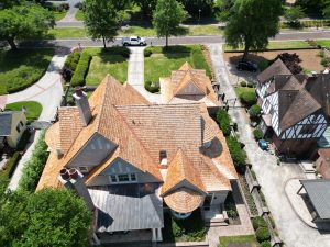 Drone image of a large home with a newly-installed cedar-shake roof | Residential Roofing Projects