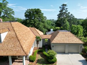 Drone image of a large home with a newly-installed cedar-shake roof | Residential Roofing Projects
