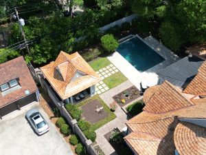 Drone image of a large home with a newly-installed cedar-shake roof | Residential Roofing Projects