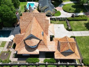 Aerial drone image of a large home with a newly-installed cedar-shake roof | Residential Roofing Projects