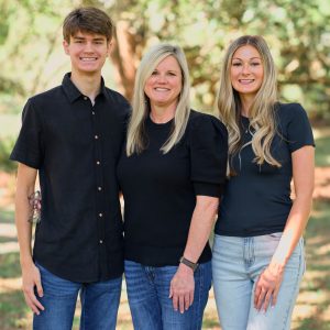 Joy Lanning | Office Manager. Joy Lanning with her young adult son and daughter.