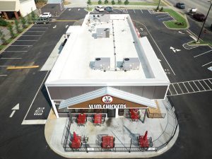 Side-angle aerial image of Slim Chickens restaurant's newly-installed commericial roof. HVAC units are also present on the roof.