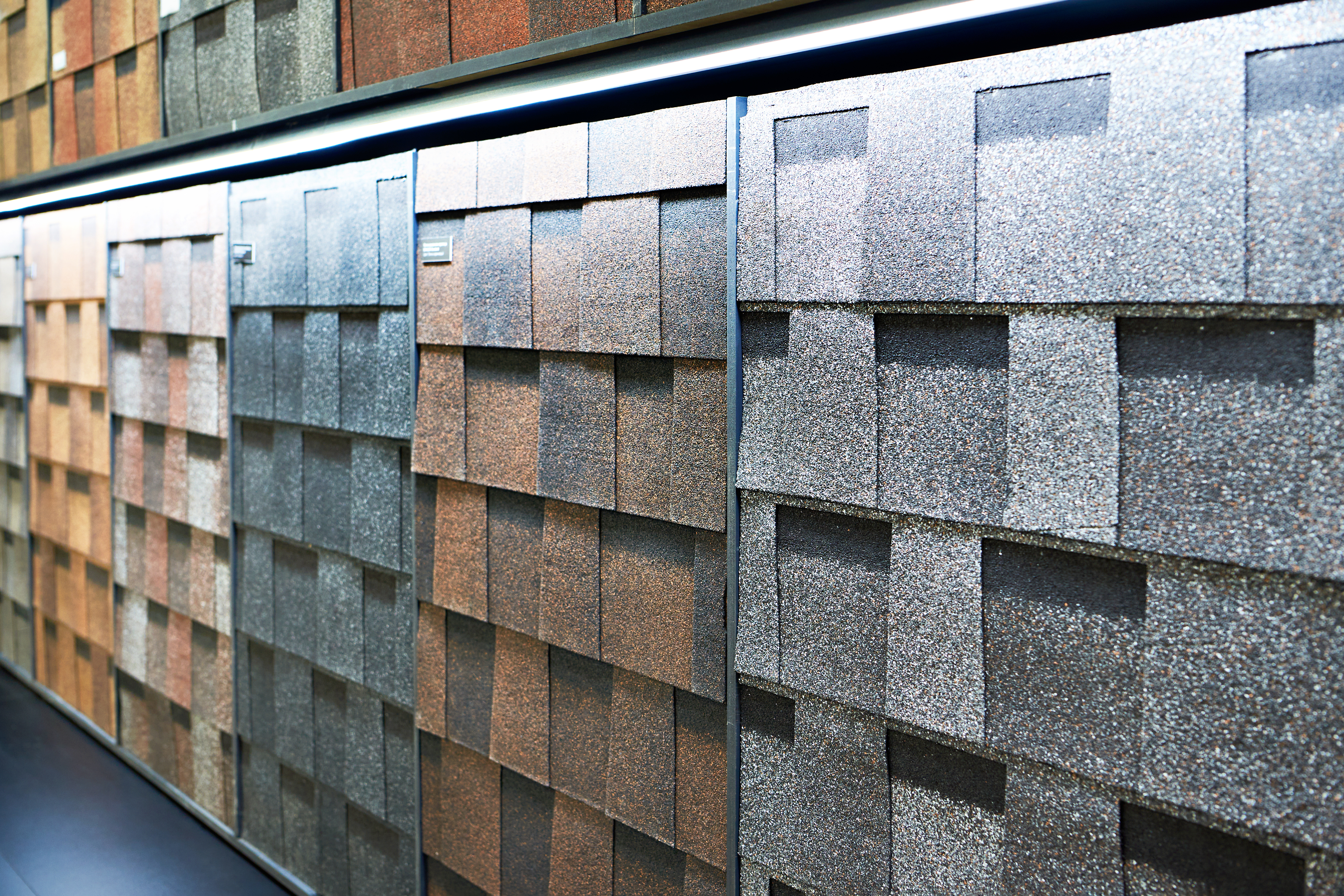 Laminate roof tiles for decorative finishing on display in store.